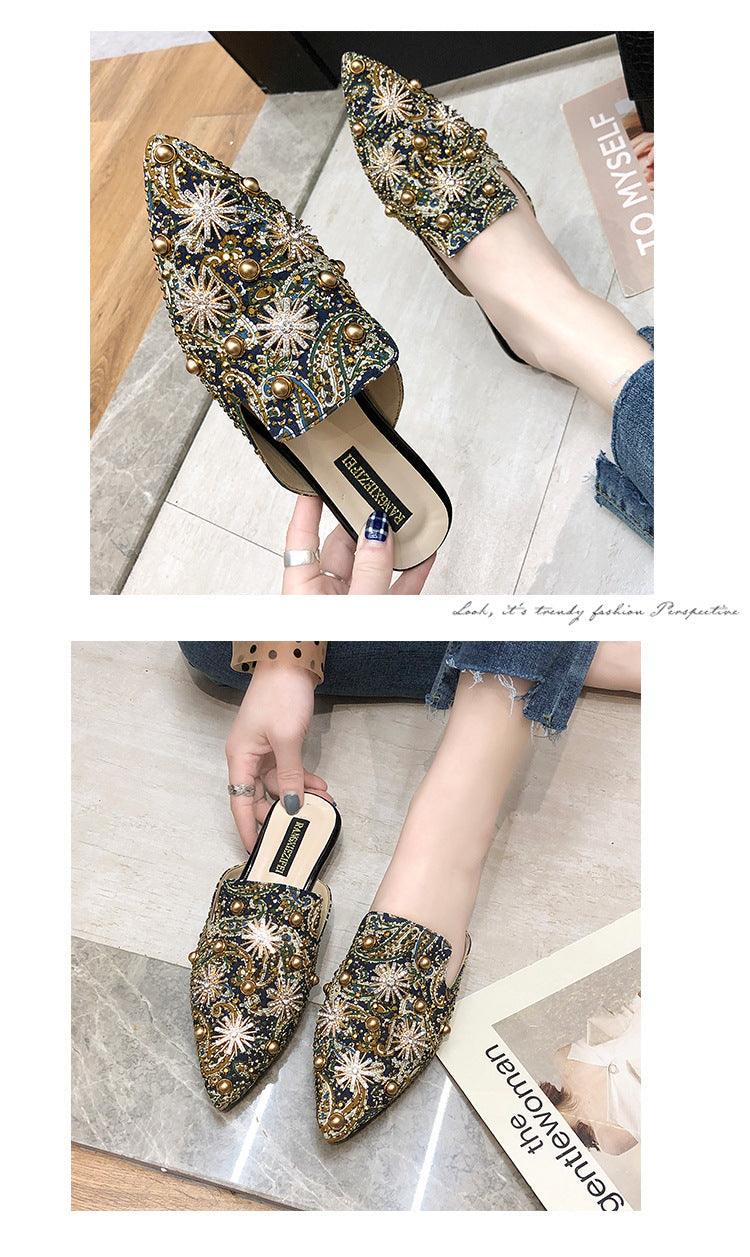 Ornate pointed-toe mules with multicolor gem embroidery and low flat heel.