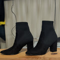 Black sock boots with block heel and pointed toe