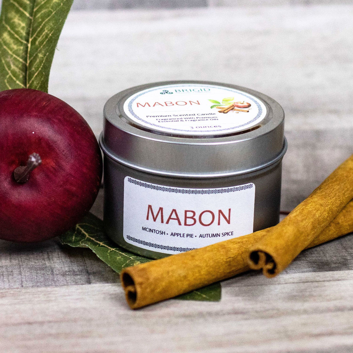 Scented soy candle with metal lid, BRIGID label, maroon apple and cinnamon sticks