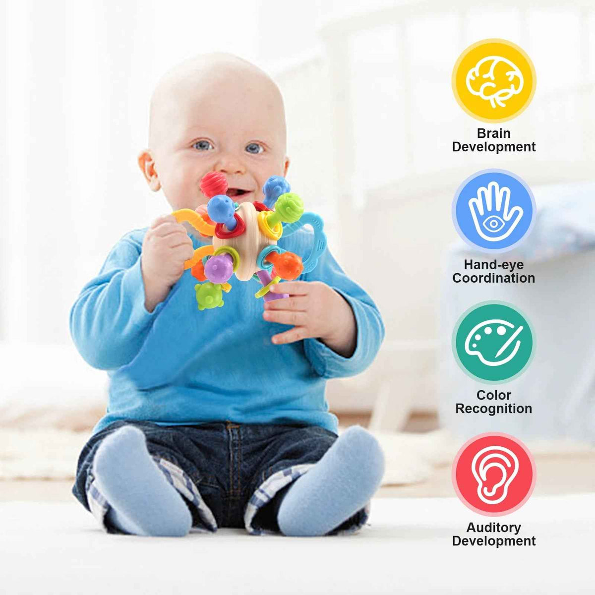 Soft silicone baby rattle teether in infant hands, with multicolor textured parts