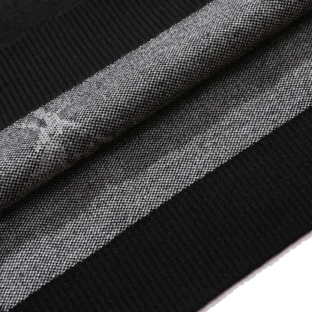 Close-up of black knit fabric texture and heathered woven panel