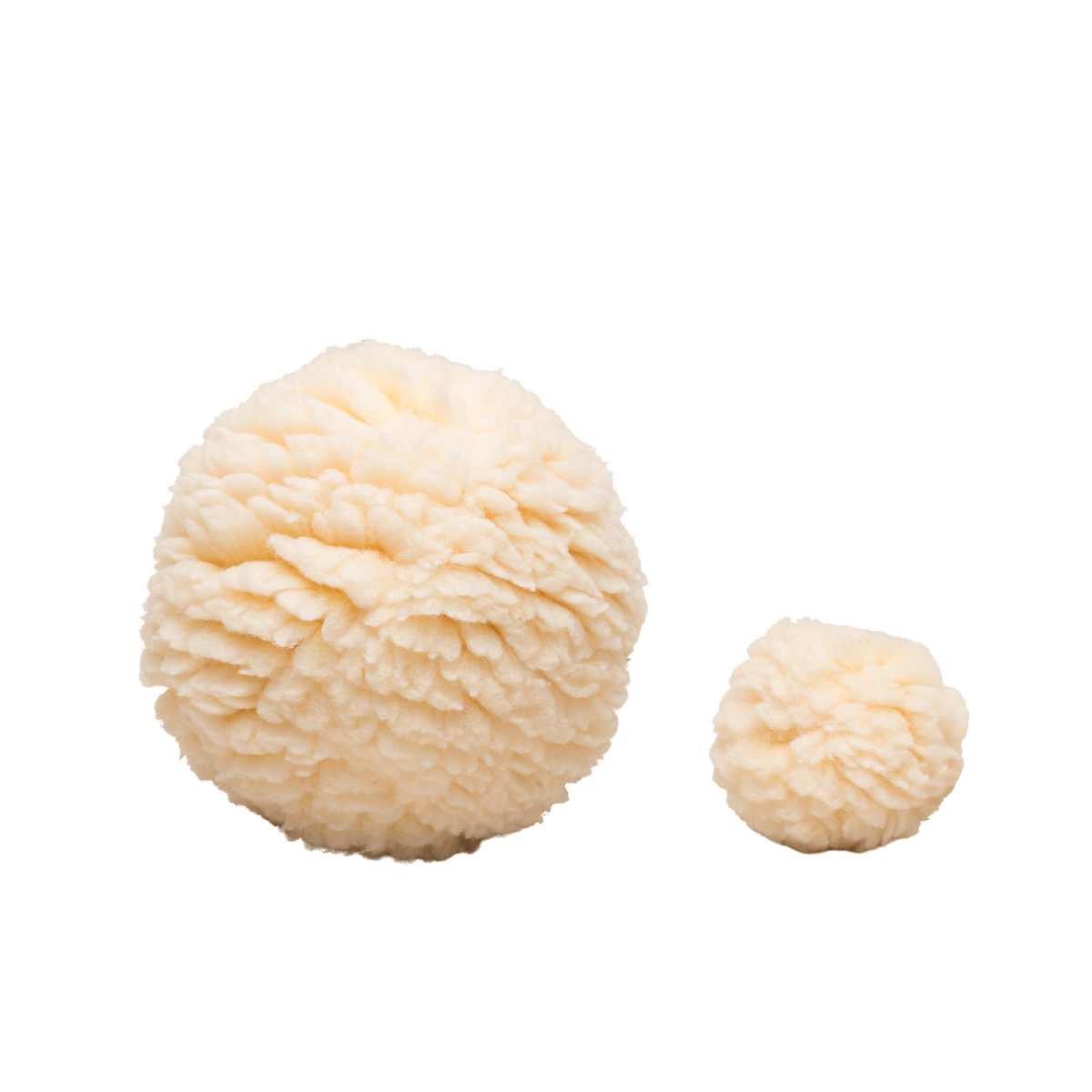 Cream plush ball dog toy with fluffy textured fabric and small matching plush piece