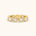 Gold eternity band ring with marquise-cut and round clear gemstones