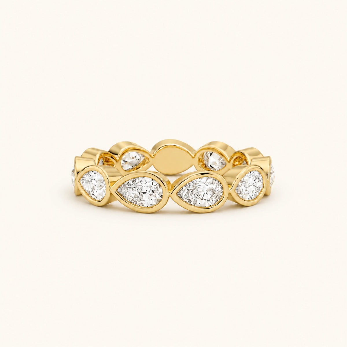 Gold eternity band ring with marquise-cut and round clear gemstones