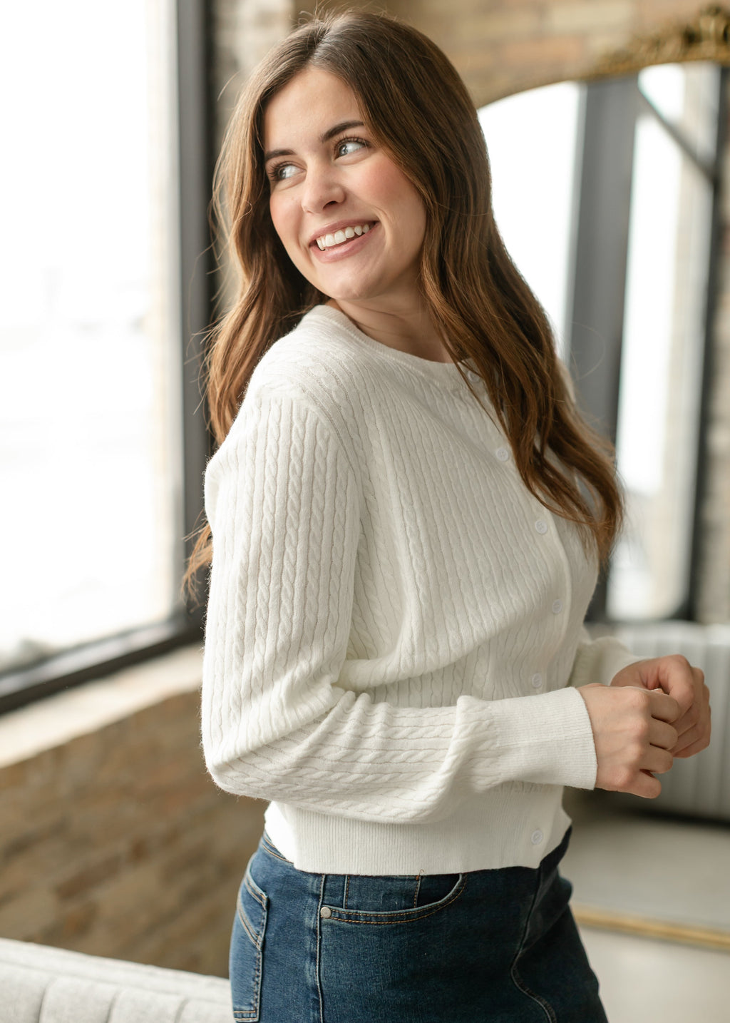 White button-up cardigan with cable-knit texture and long sleeves