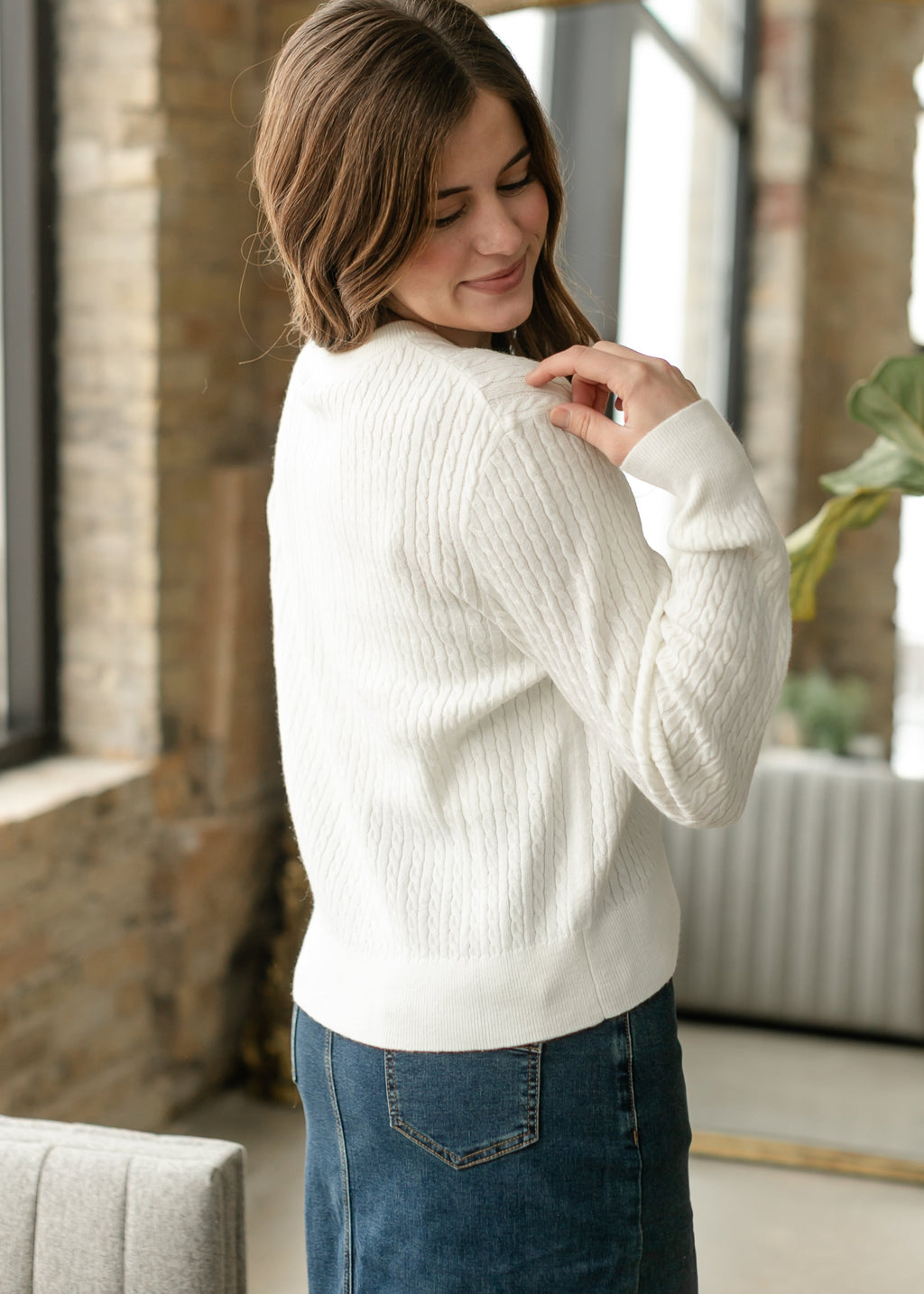 White button-up cardigan with button front and cable-knit sleeves