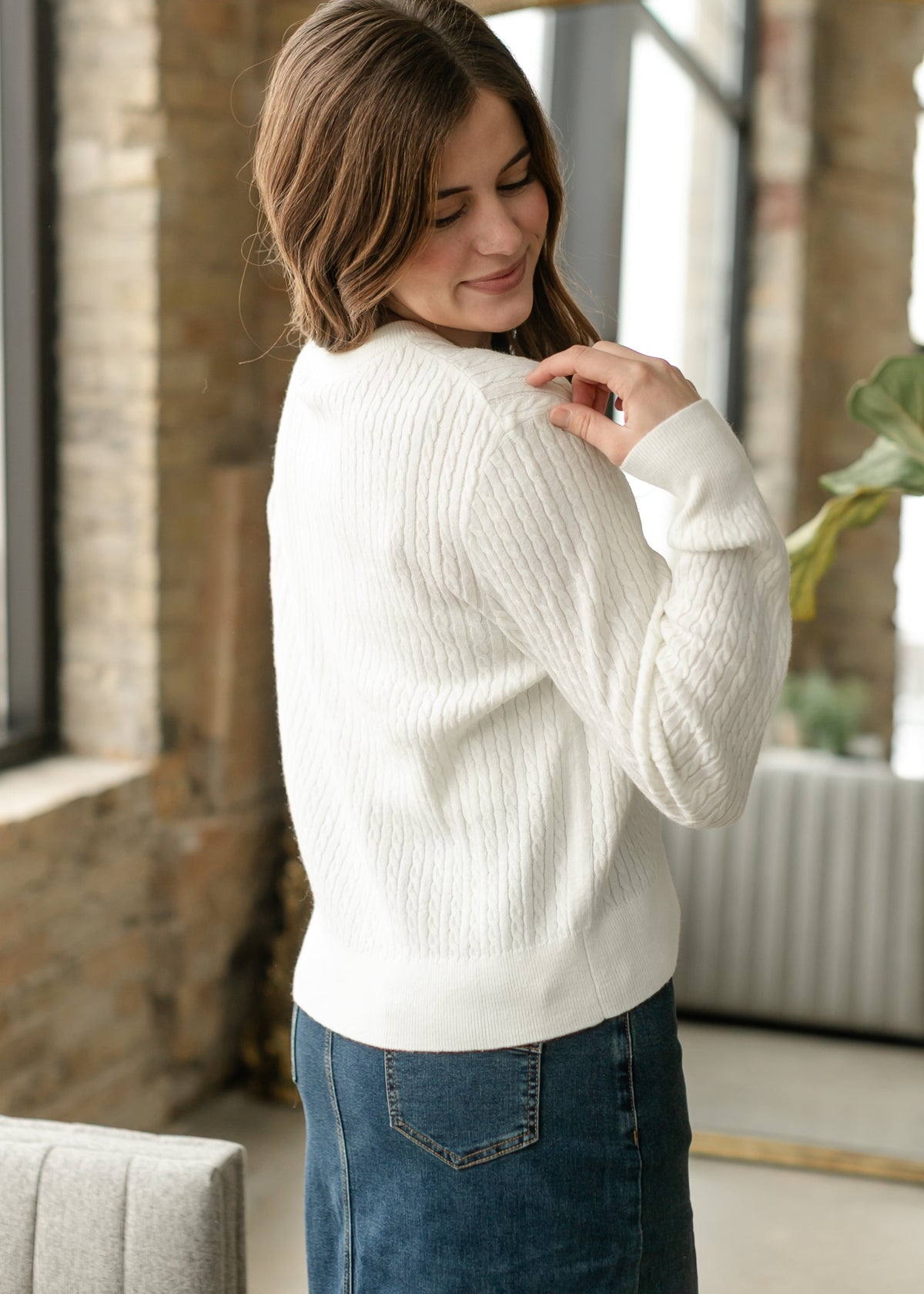 White button-up cardigan with button front and cable-knit sleeves
