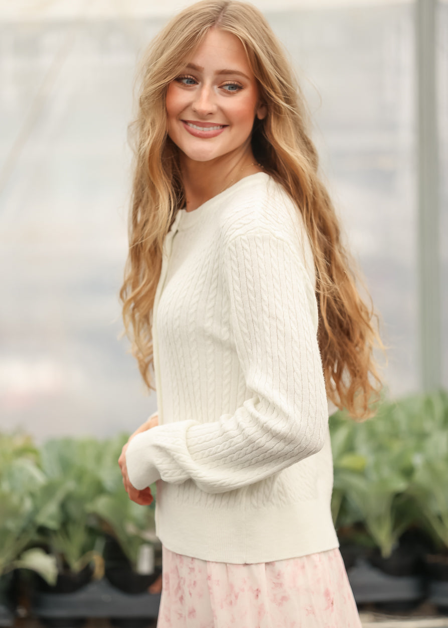 White button-up cardigan with textured knit sleeves and crew neckline