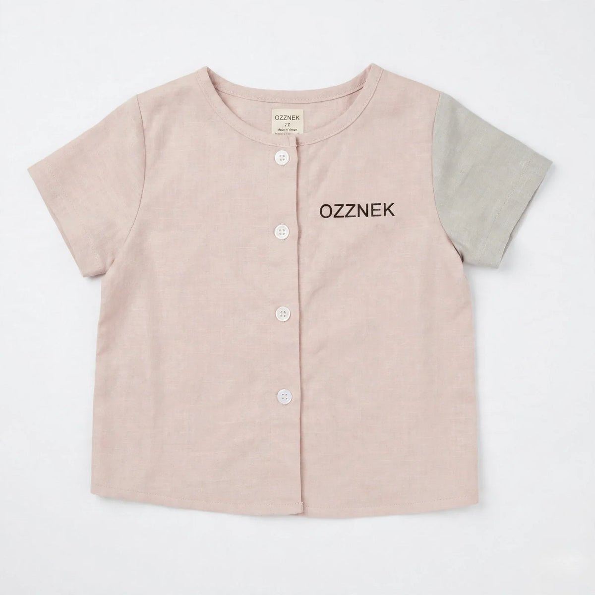 Toddler linen button-up shirt, clay pink with gray-blue sleeves; OZZNEK logo