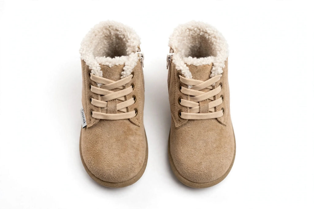 Pair of tan toddler winter barefoot boots with lace-up and fuzzy ankle lining