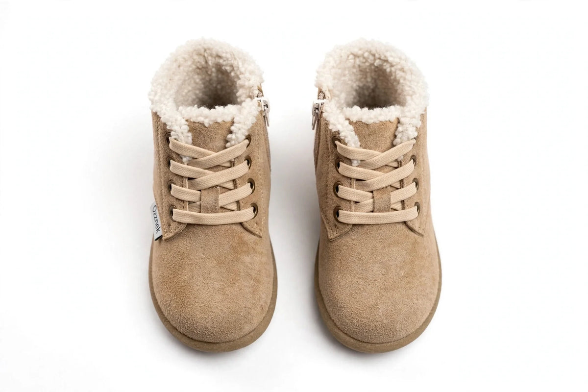 Pair of tan toddler winter barefoot boots with lace-up and fuzzy ankle lining