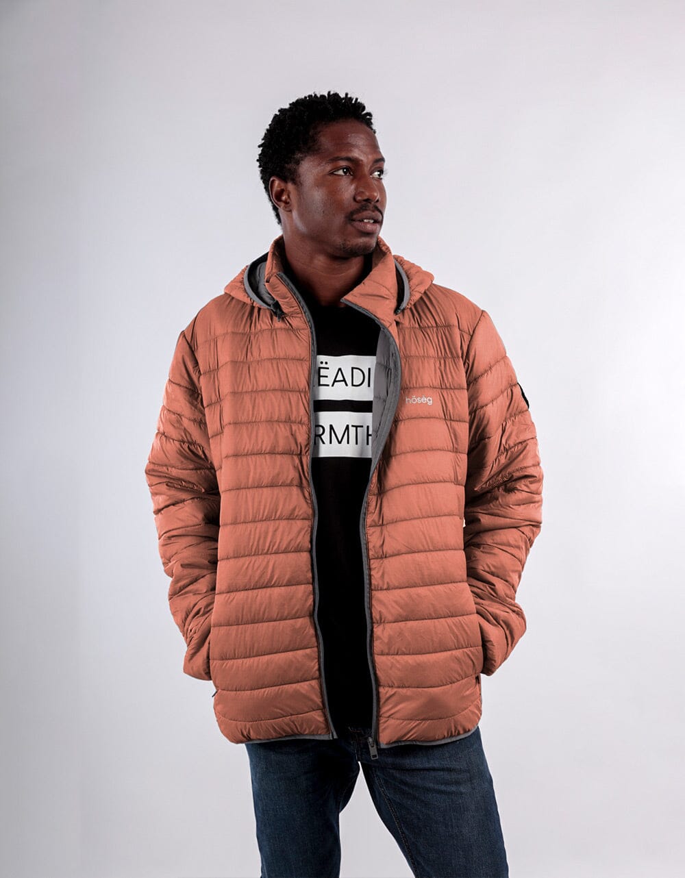 Orange men's puffer jacket with zip front, stand collar, and quilted insulation