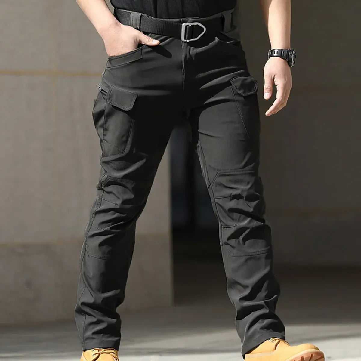 Black men's cargo pants with multiple utility pockets and straight tapered legs
