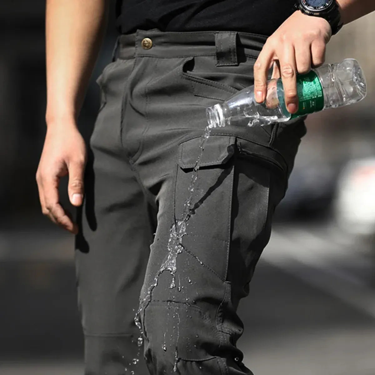 Black waterproof cargo pants with reinforced leg pockets and water beading