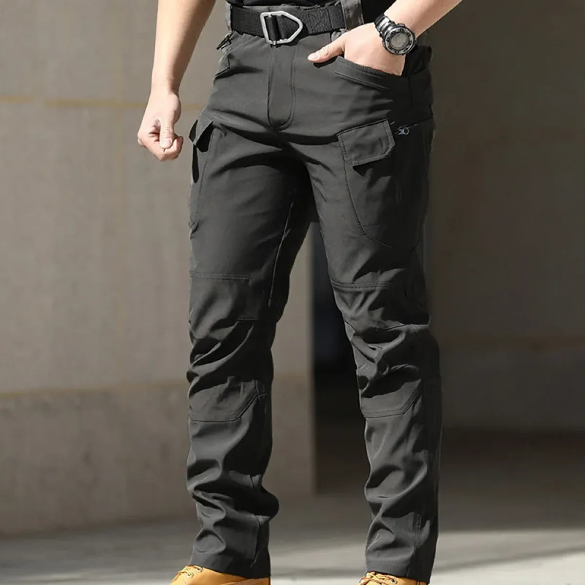Black men's cargo pants with cargo flap pockets and adjustable waistband