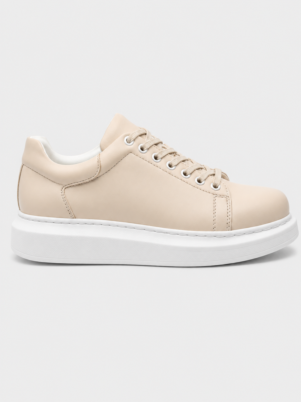 Cream low-top lace-up sneakers with white rubber sole and side stitching