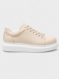 Cream low-top lace-up sneakers with white rubber sole and side stitching