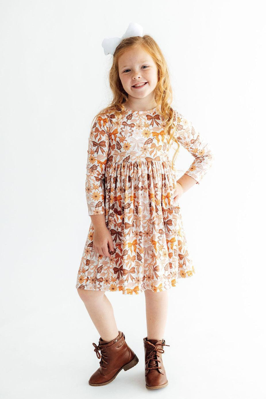 Orange floral long-sleeve twirl dress, gathered waist and knee-length skirt