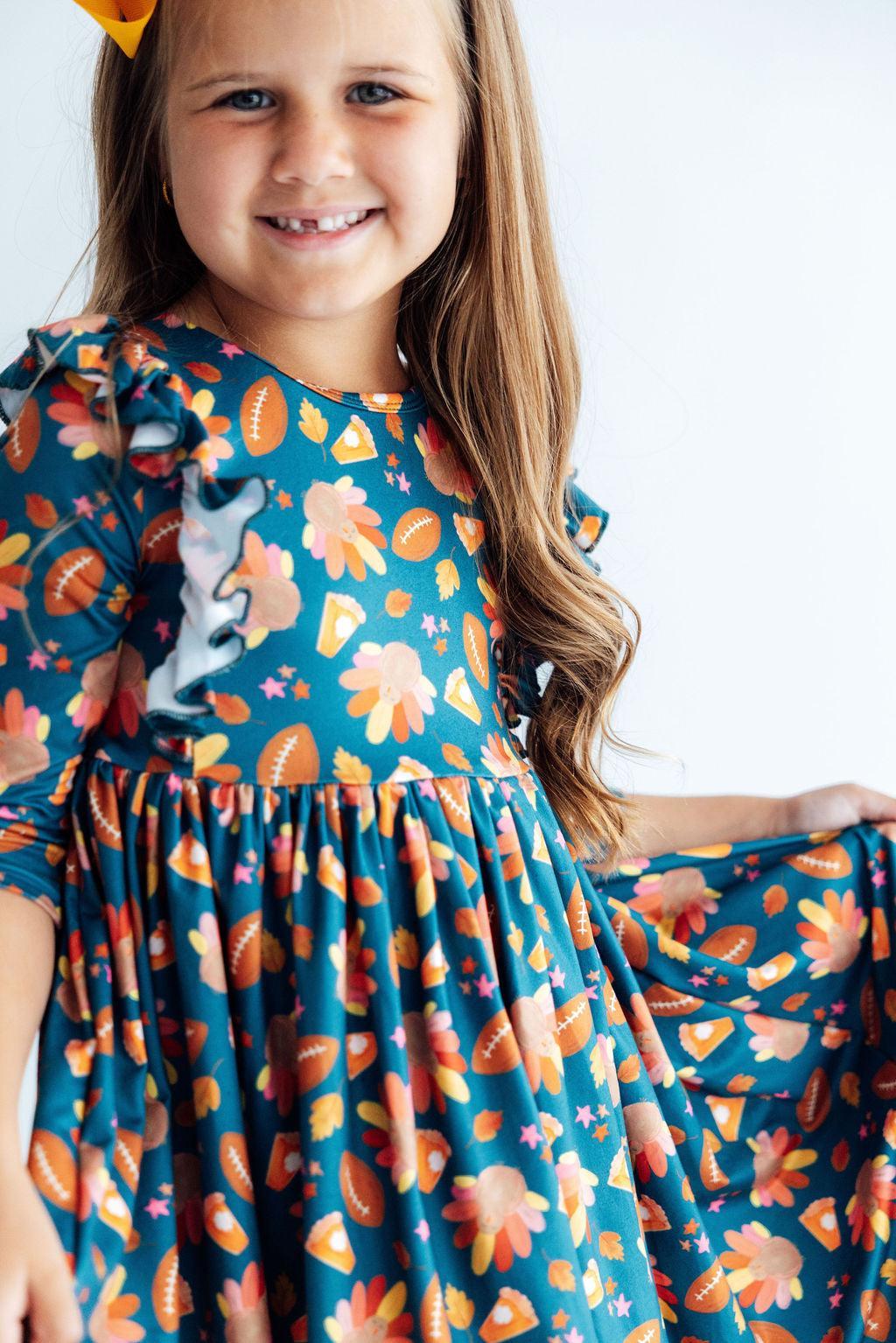 Teal 3/4 sleeve ruffle dress with gathered skirt and orange peach allover print