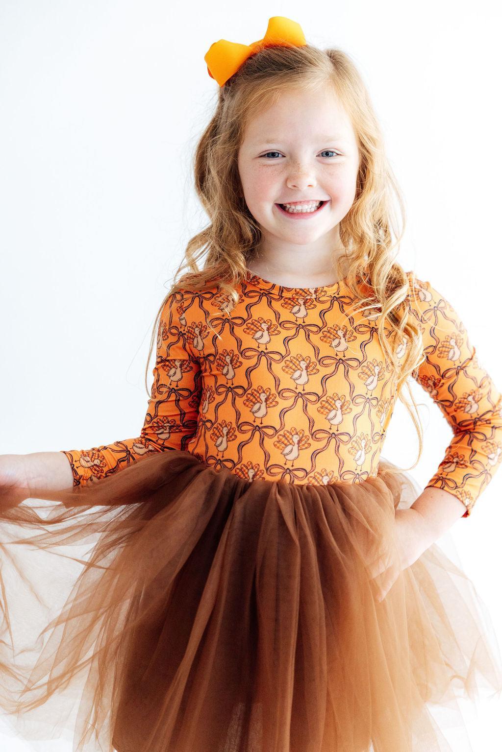 Orange turkey-print long-sleeve dress with layered brown tulle skirt and bow headband