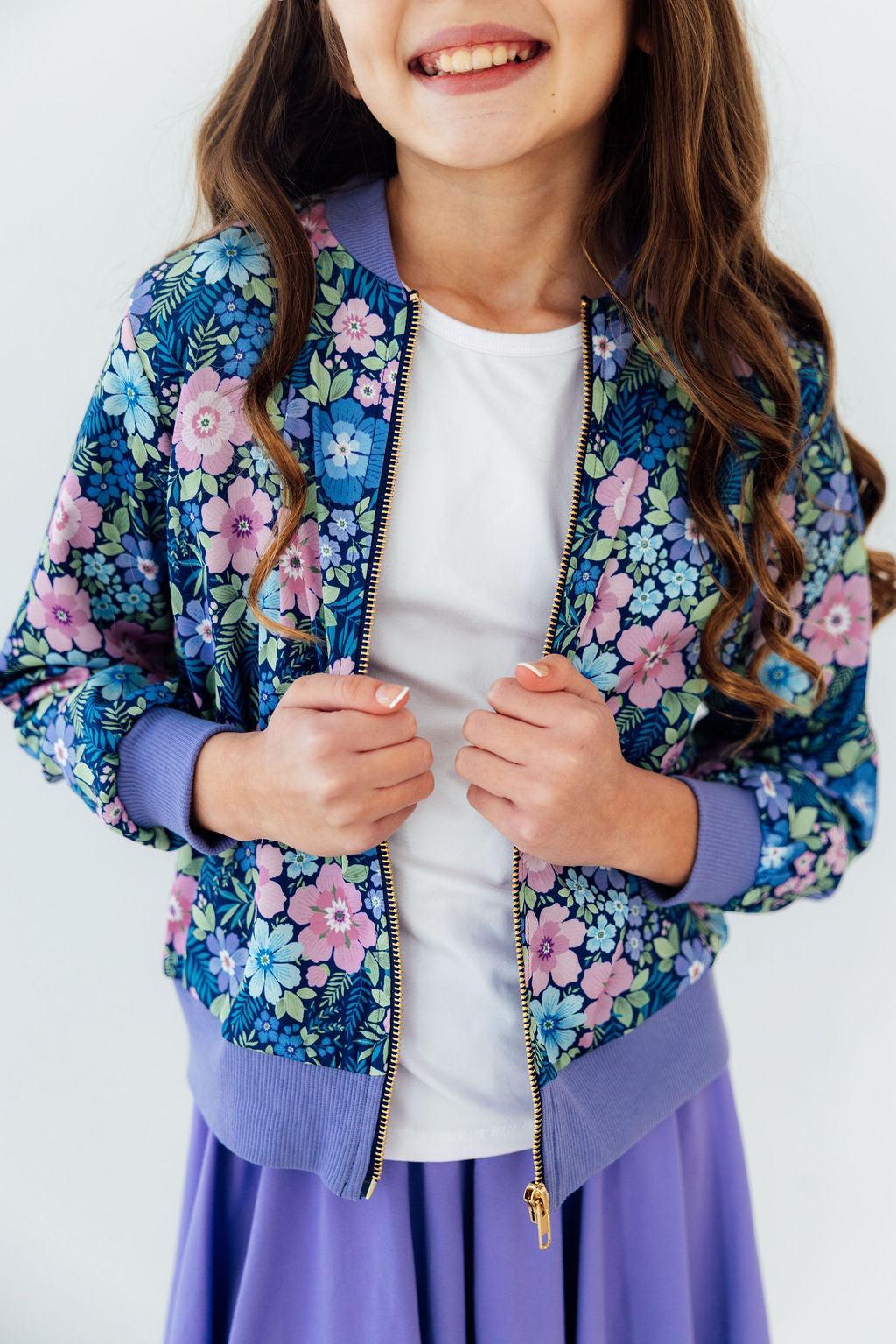 Floral satin zip jacket with purple ribbed cuffs and hem, blue and pink flower print