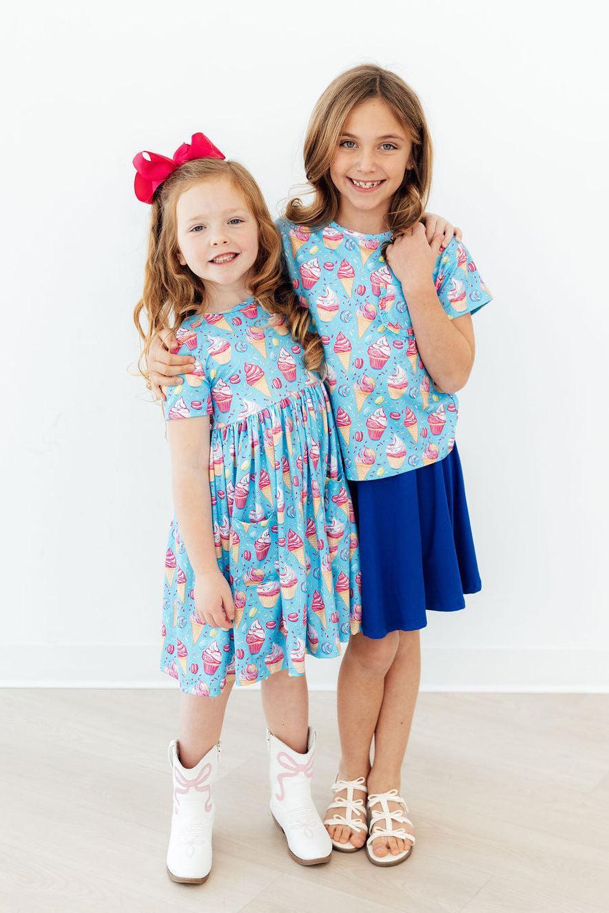 Light blue dessert-print short-sleeve twirl dress with gathered skirt and round neck