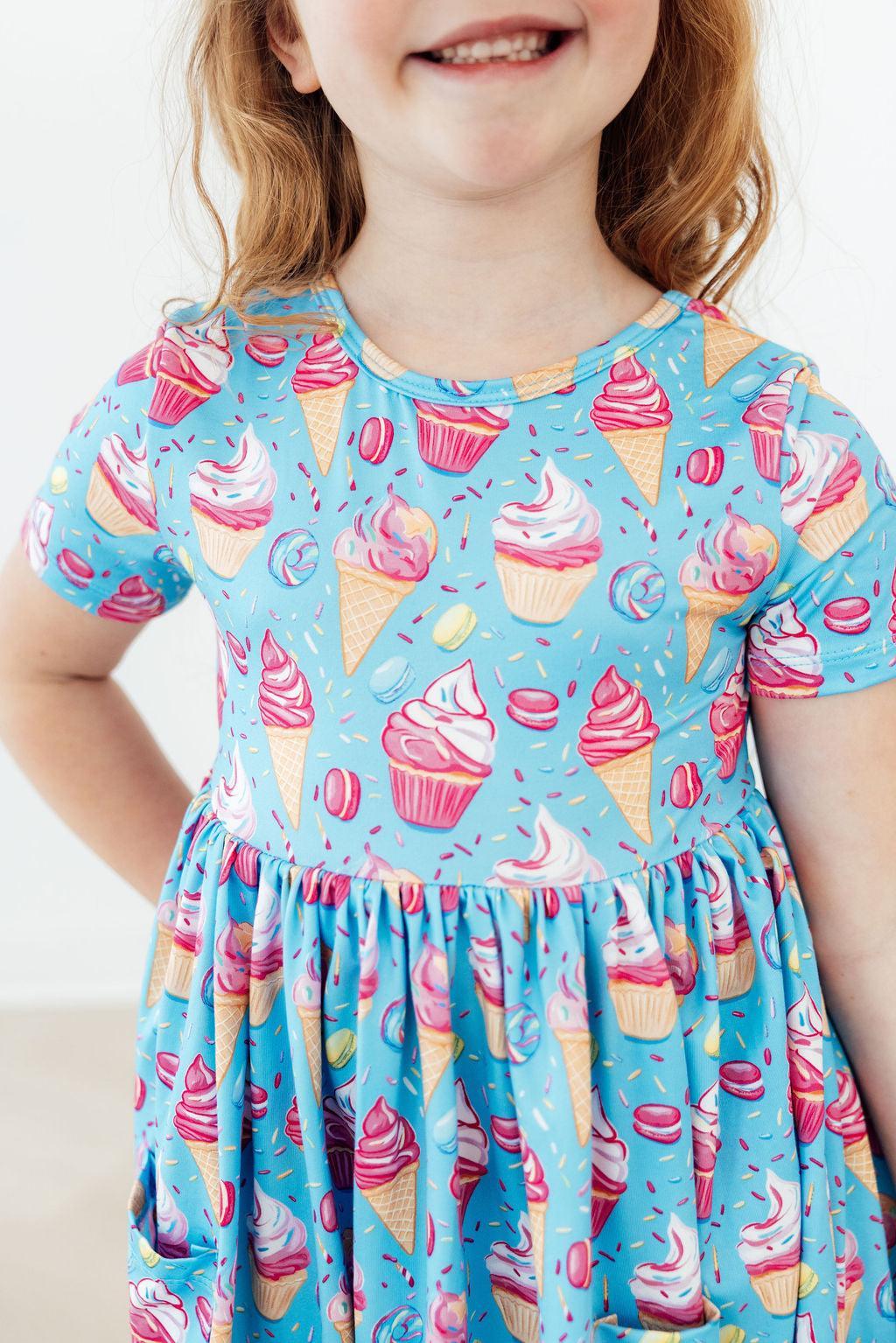 Light blue short-sleeve twirl dress with pink and yellow dessert print