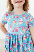 Light blue short-sleeve twirl dress with pink and yellow dessert print