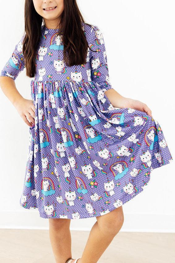 Girls purple cat-print twirl dress with 3/4 sleeves and colorful unicorn motifs