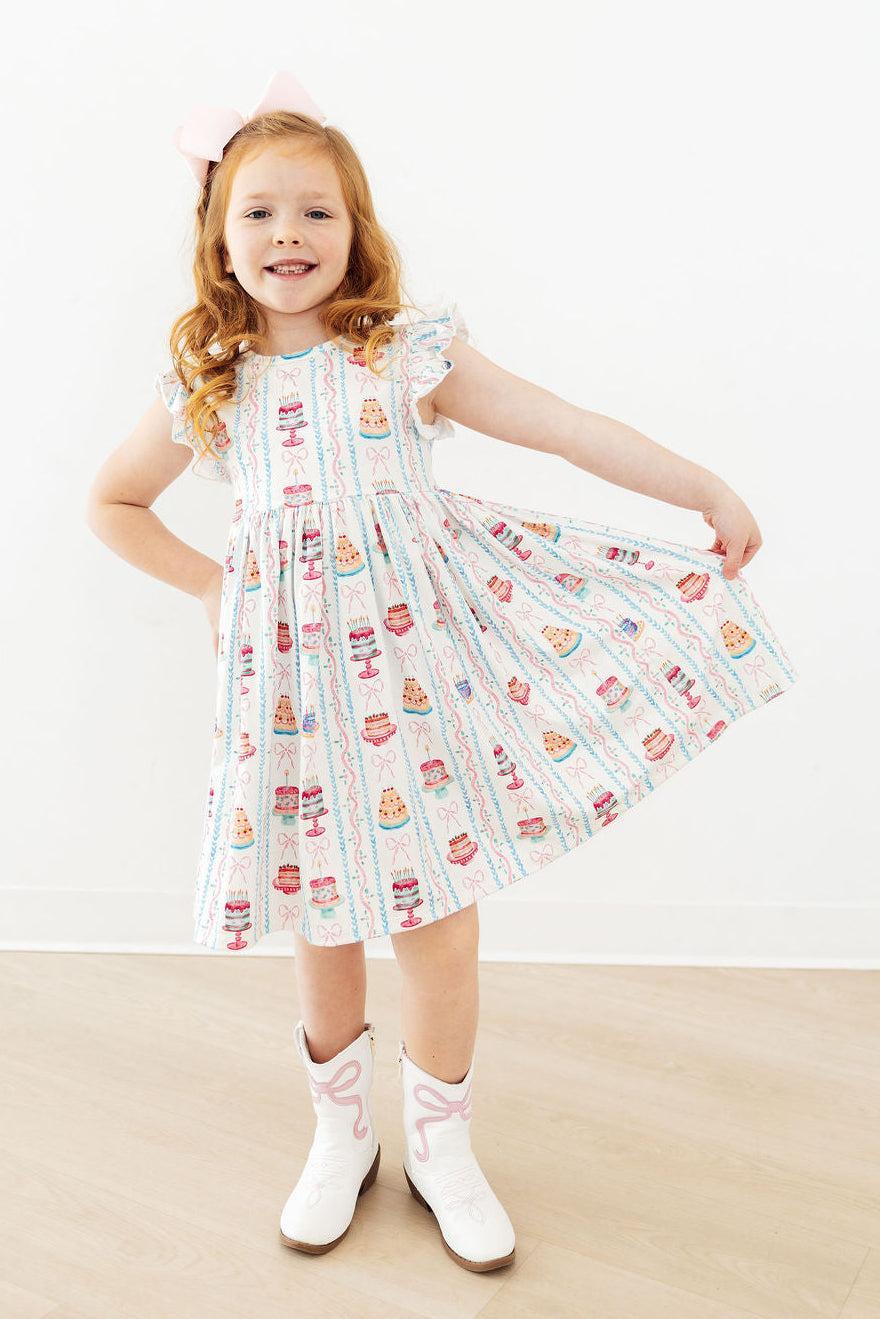 White cake-print twirl dress with flutter sleeves and gathered bodice