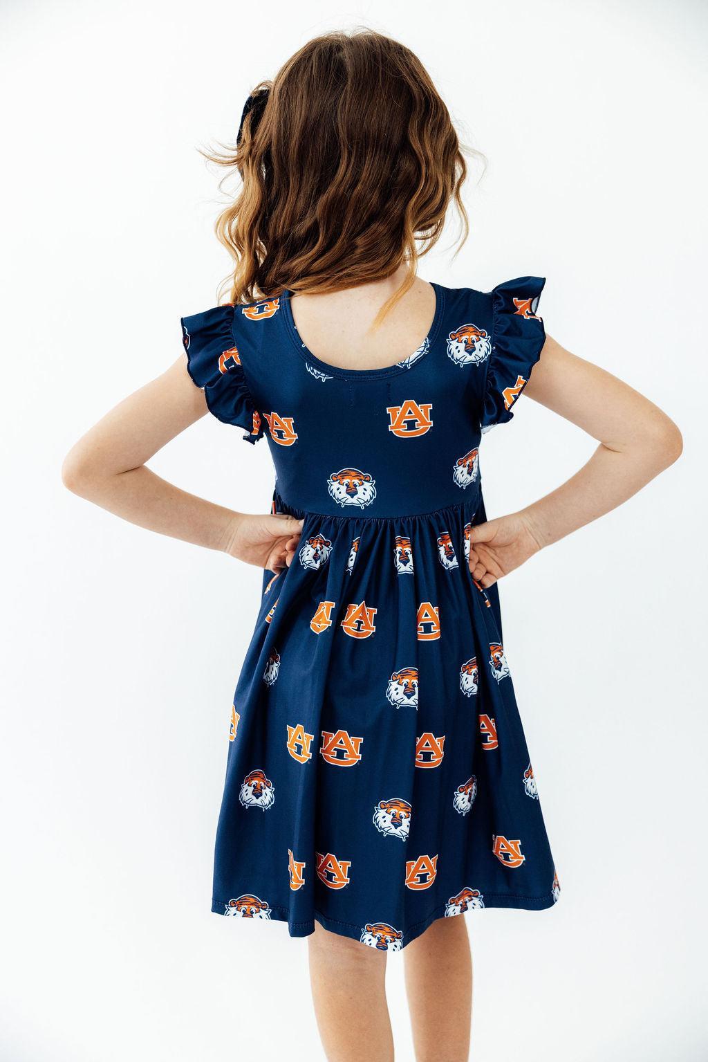 Aubie flutter twirl dress back view with ruffled cap sleeves and logo print