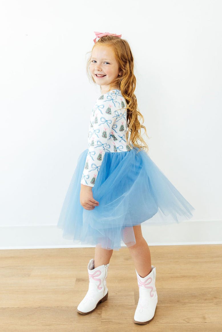 Side view of light blue tulle tutu dress with long sleeves and white bow-and-tree print