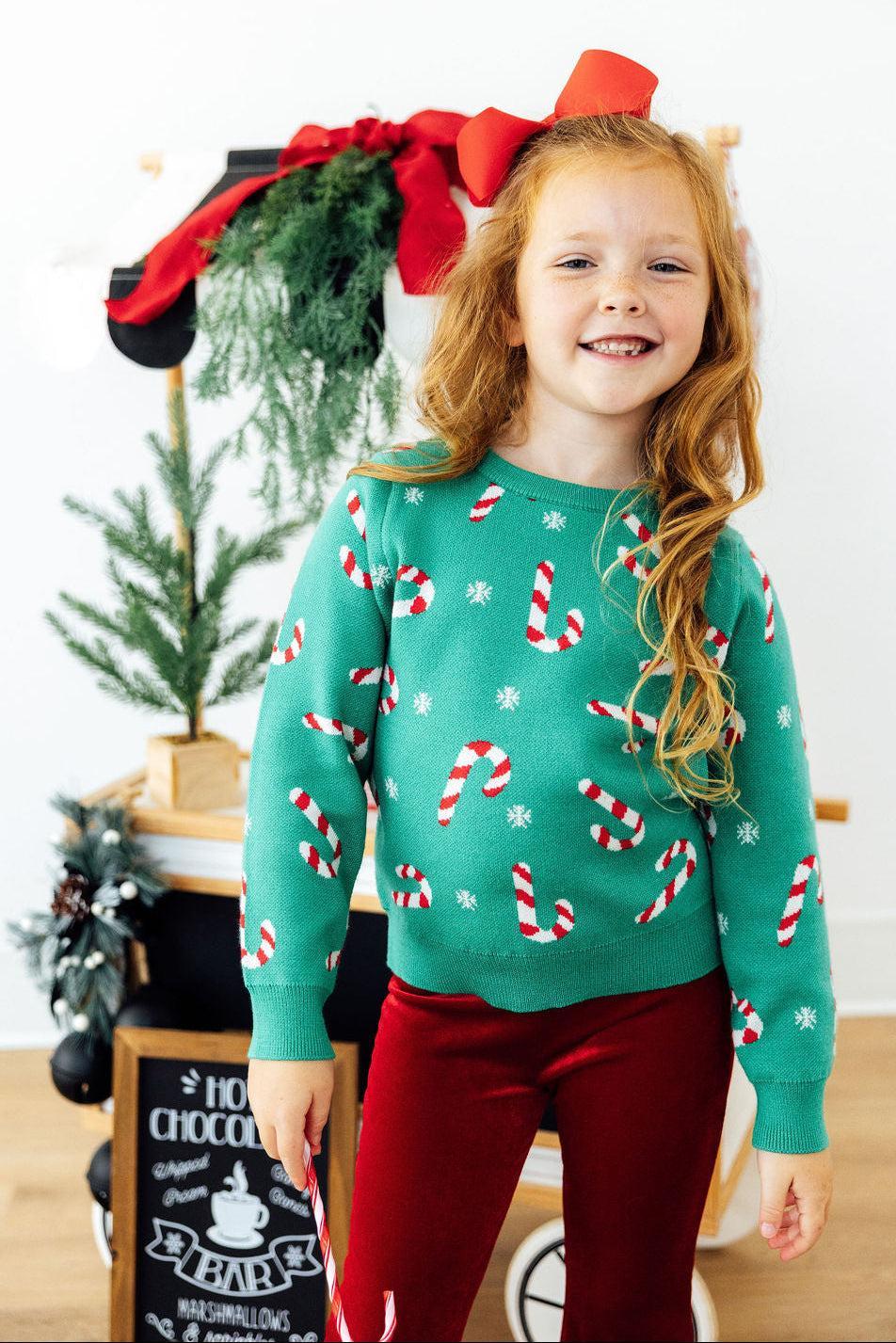 Kids teal Christmas sweater with white and red candy cane pattern, long sleeves, crew neck
