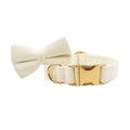 Ivory velvet dog collar with large bowtie and gold-tone buckle hardware