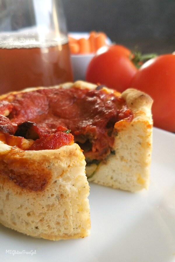 Two gluten-free pizza slices with tomato sauce, cheese, and pepperoni