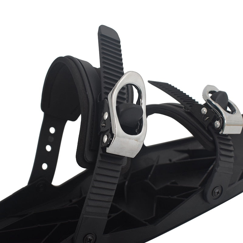 Black mini ski skates with ribbed heel lever and silver buckle bindings