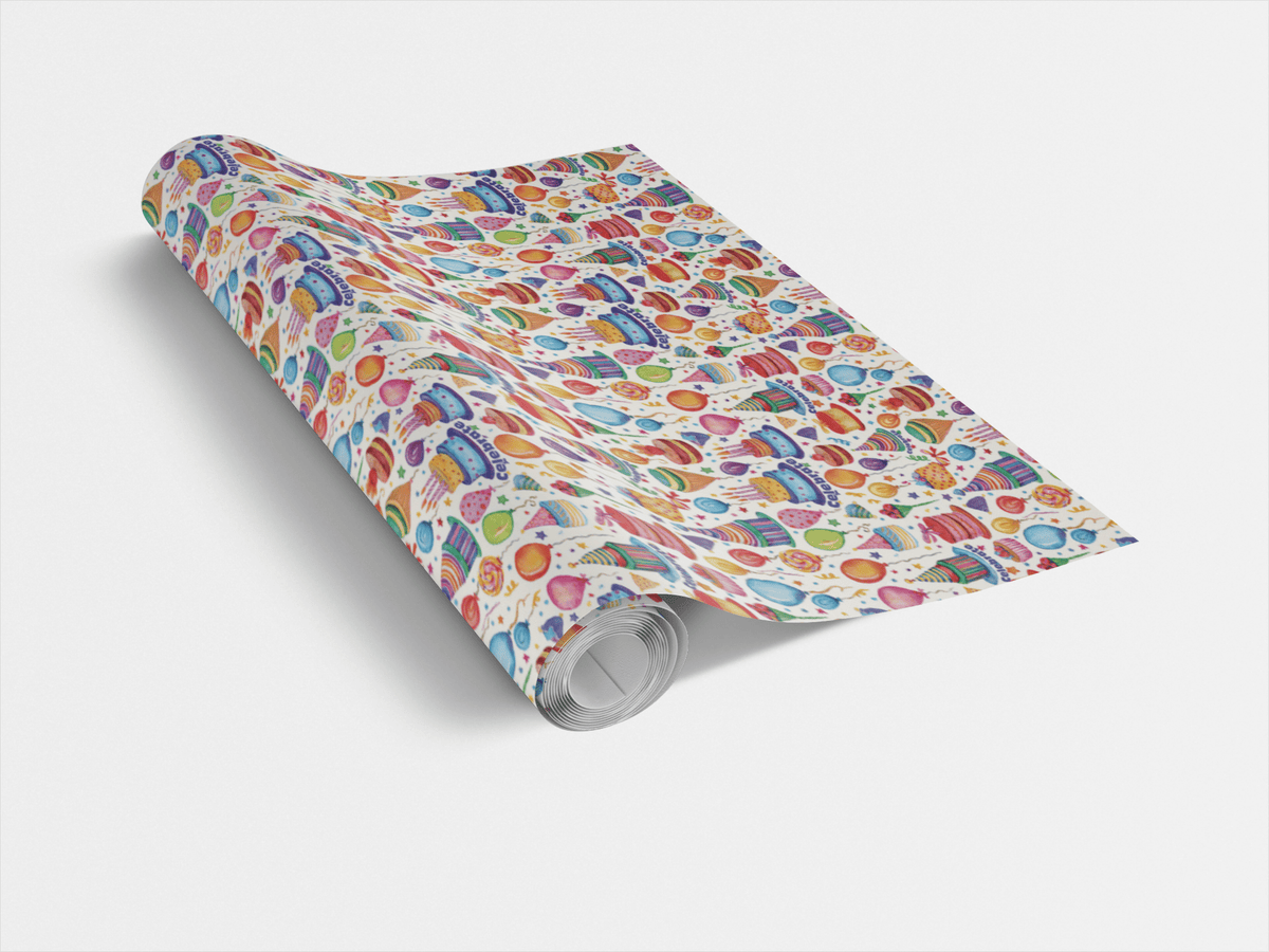 Wrapping paper roll showing repeating multicolor cake and balloon design