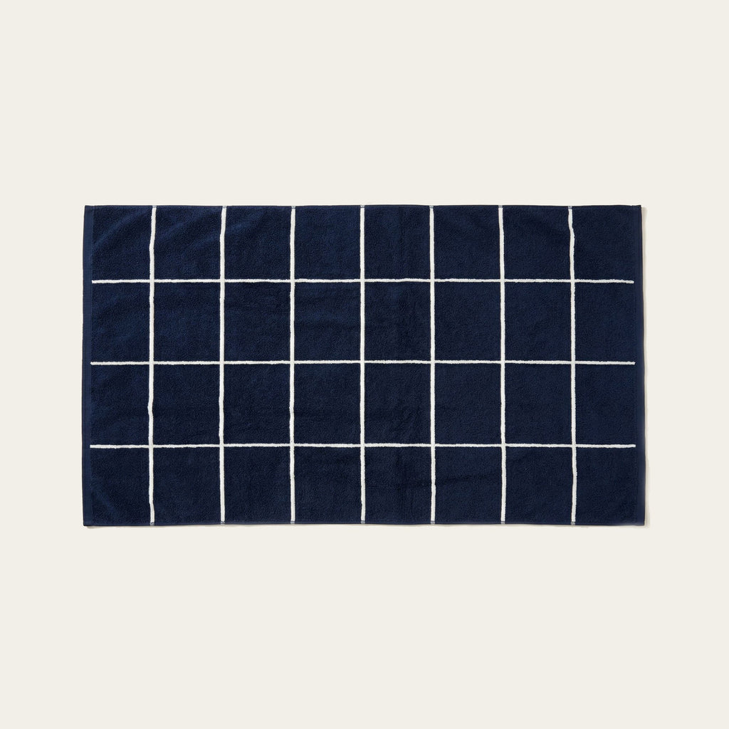 Navy and white striped cotton towel with grid line pattern