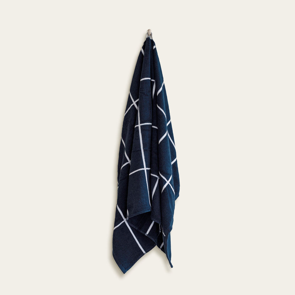 Navy cotton washcloth with white crisscross stripe pattern