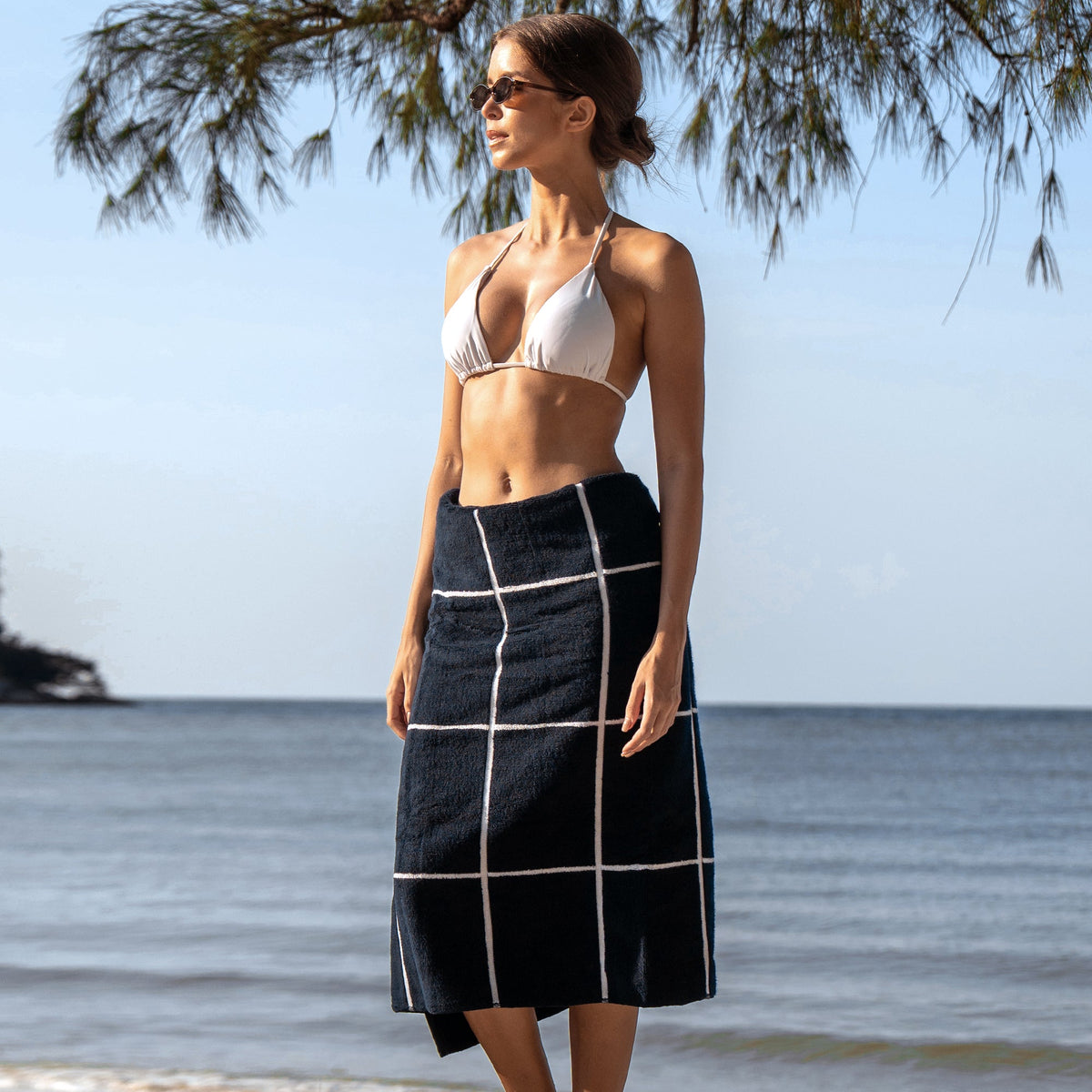 Black bath towel skirt with white grid stripes, worn on the body
