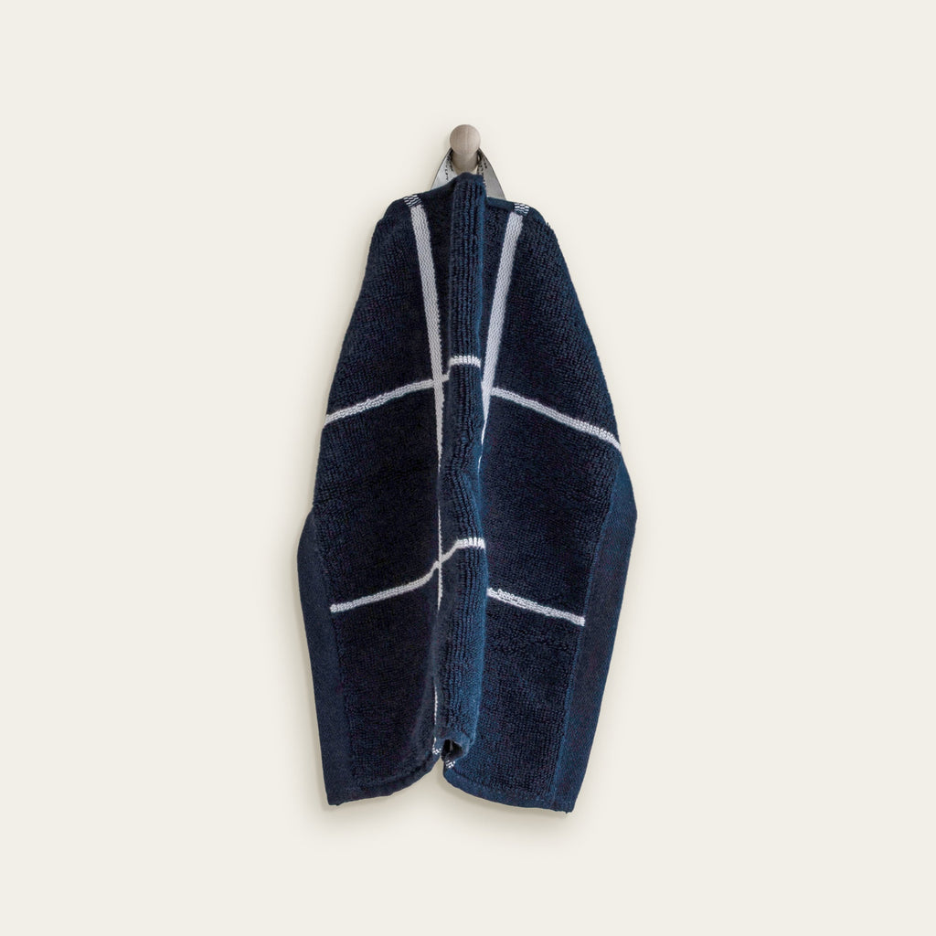 Navy cotton towel with white window-grid stripe pattern, folded