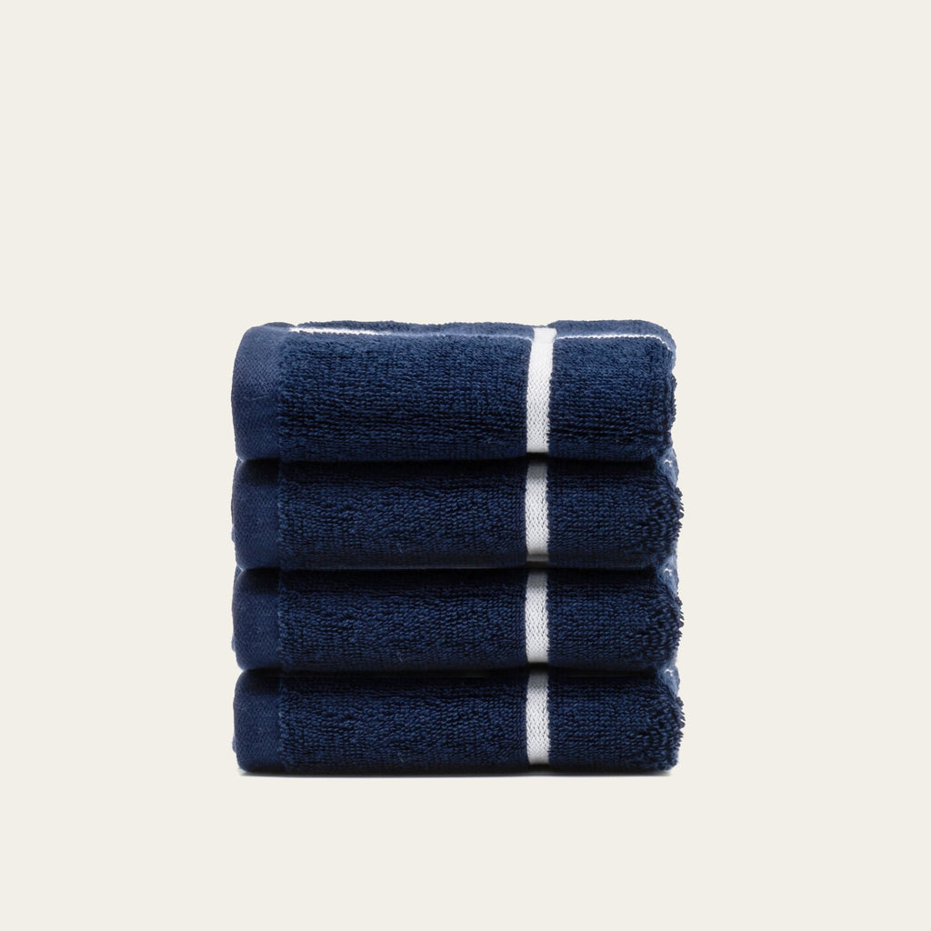 Folded navy cotton towel with two white stripe bands