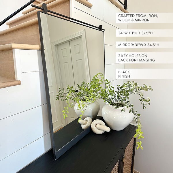 Rectangular wall mirror with black metal frame and clear glass panel