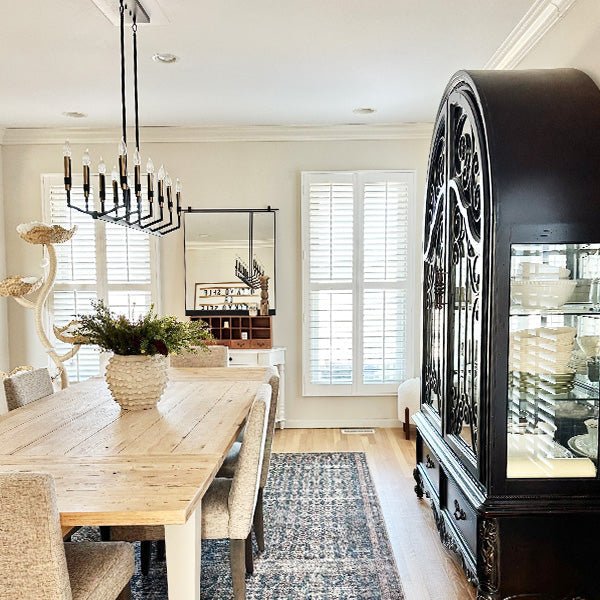 Large rectangular mirror with black metal frame and decorative arched border