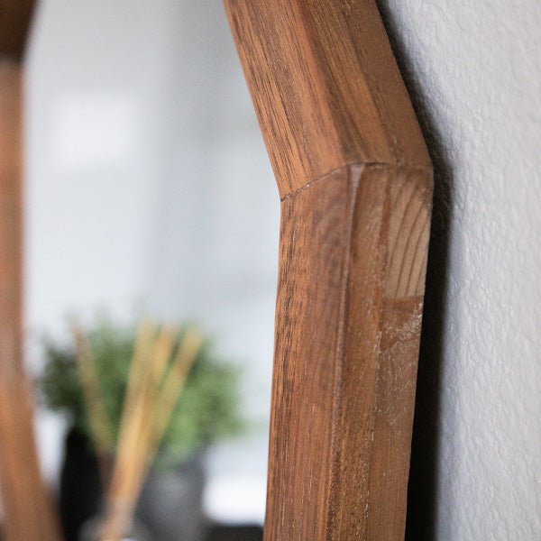 Octagon mirror frame wood close-up, angled brown panel with visible grain