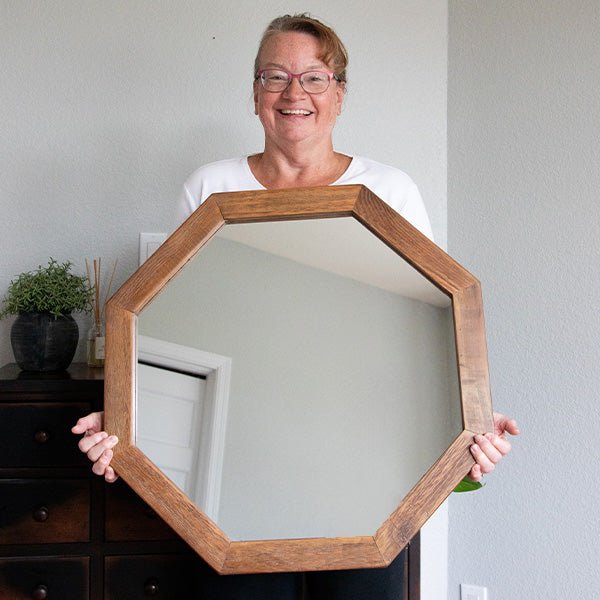 Octagon wood frame mirror held up, brown octagonal frame with clear reflective glass