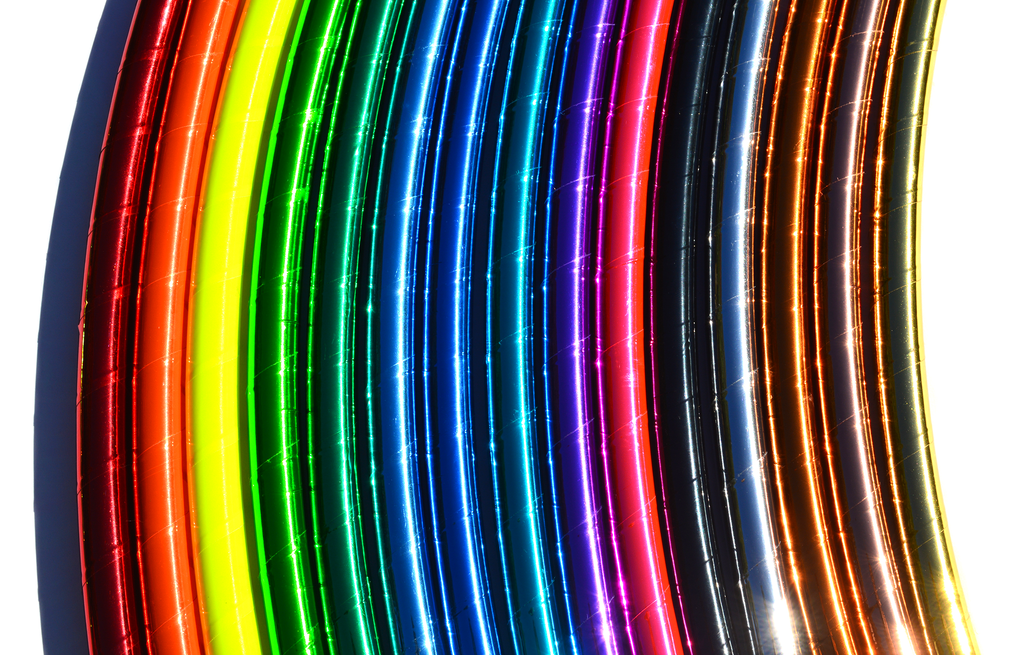 Colorful reflective hula hoops with rainbow tape bands on curved tubes