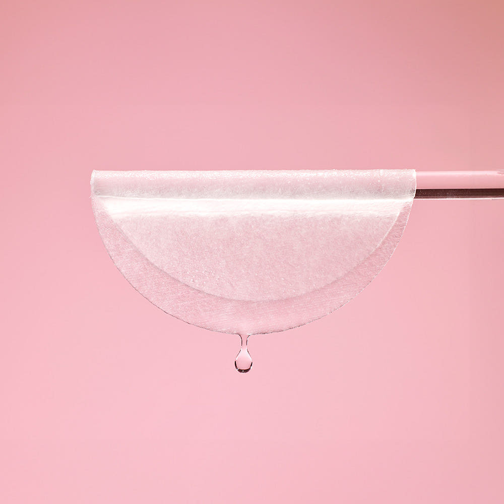 Translucent collagen toner pad sheet with a visible droplet