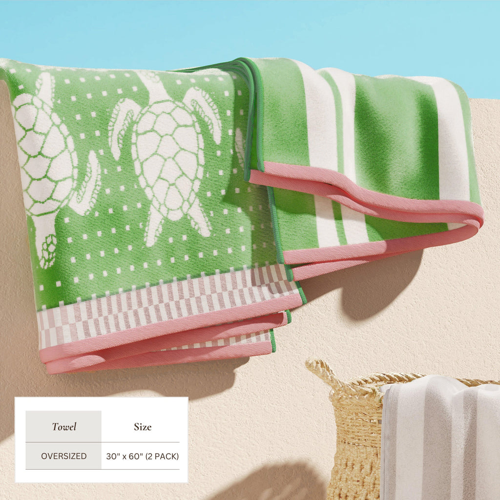 Green and white stripe cotton velour towel bundle with pink accents, shown folded