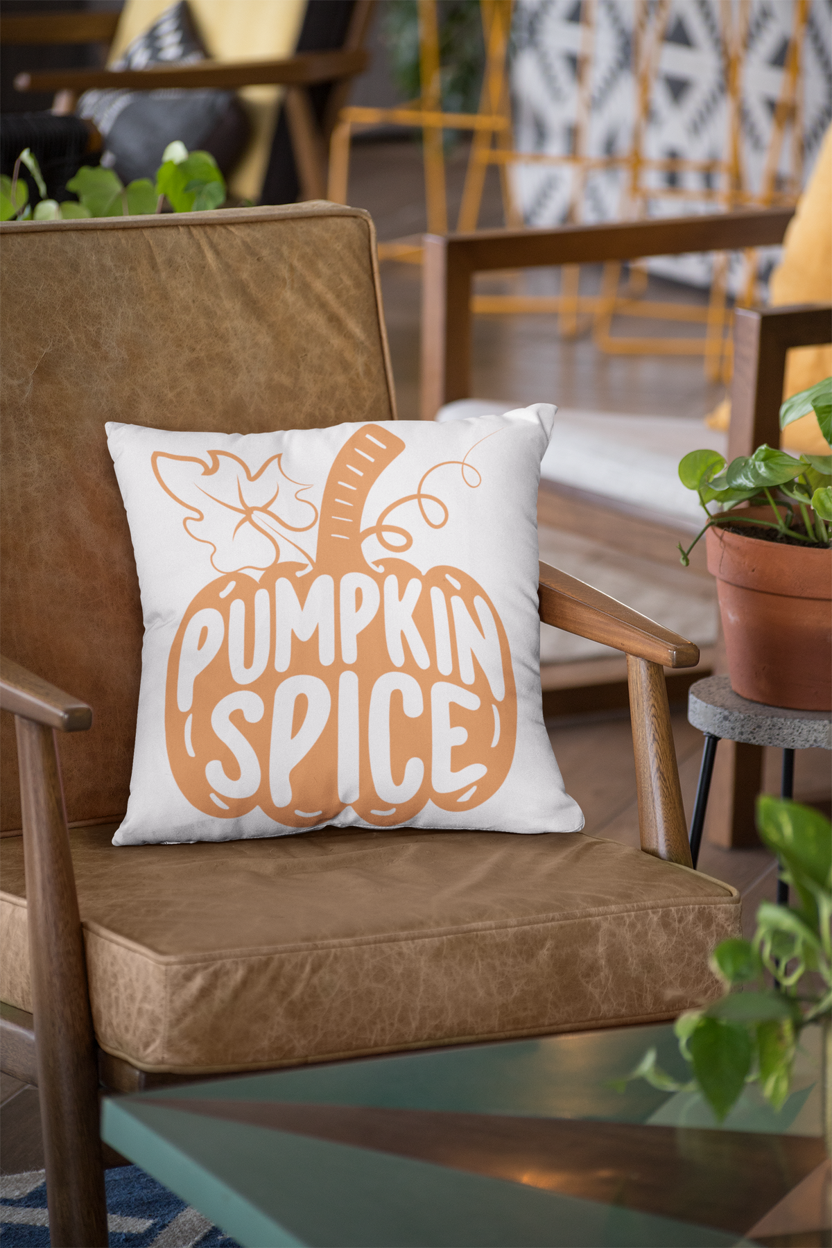 White 18x18 throw pillow with orange pumpkin spice graphic